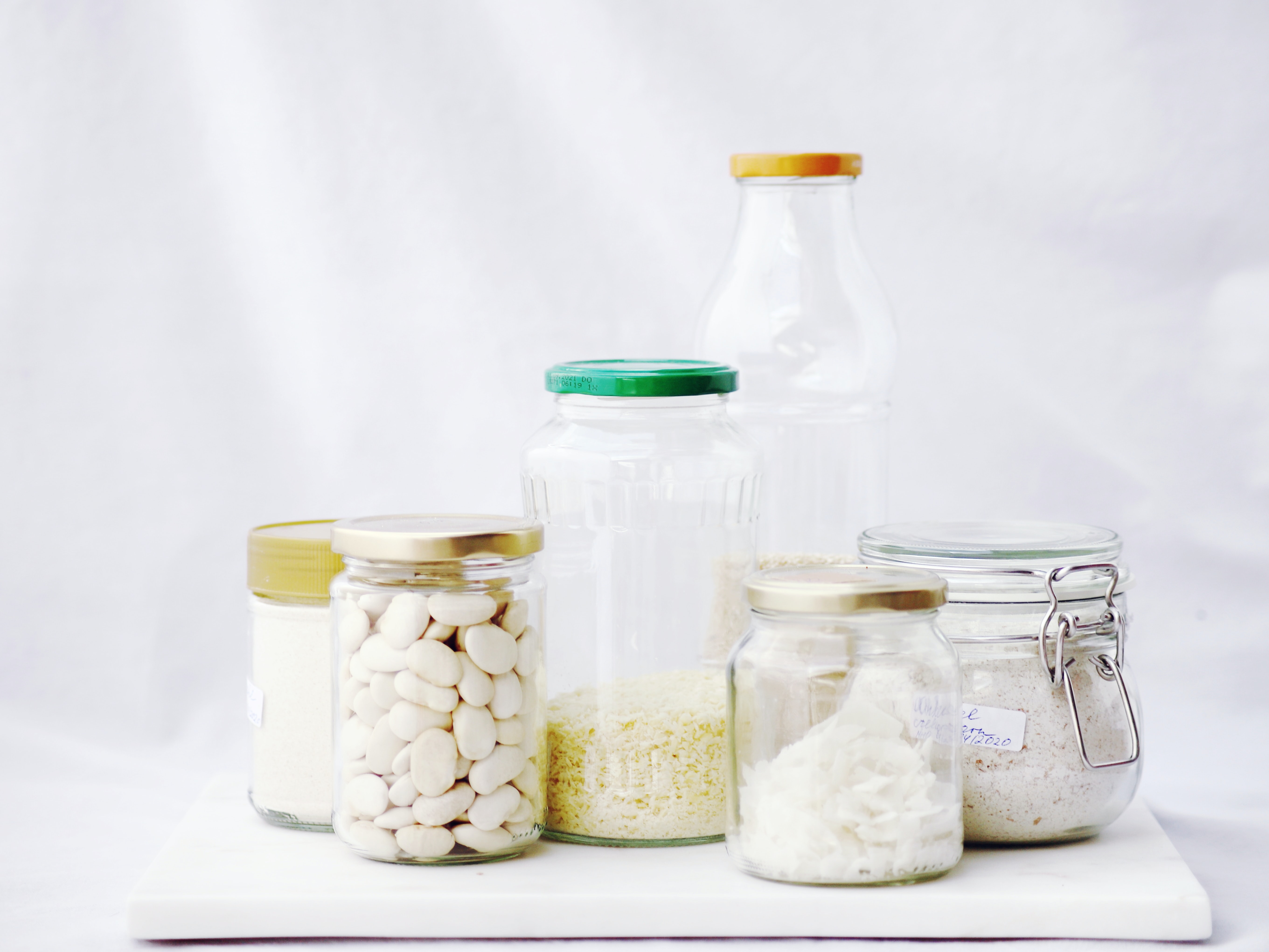 various sizes of glass jars holding different pantry staples like beans and rice