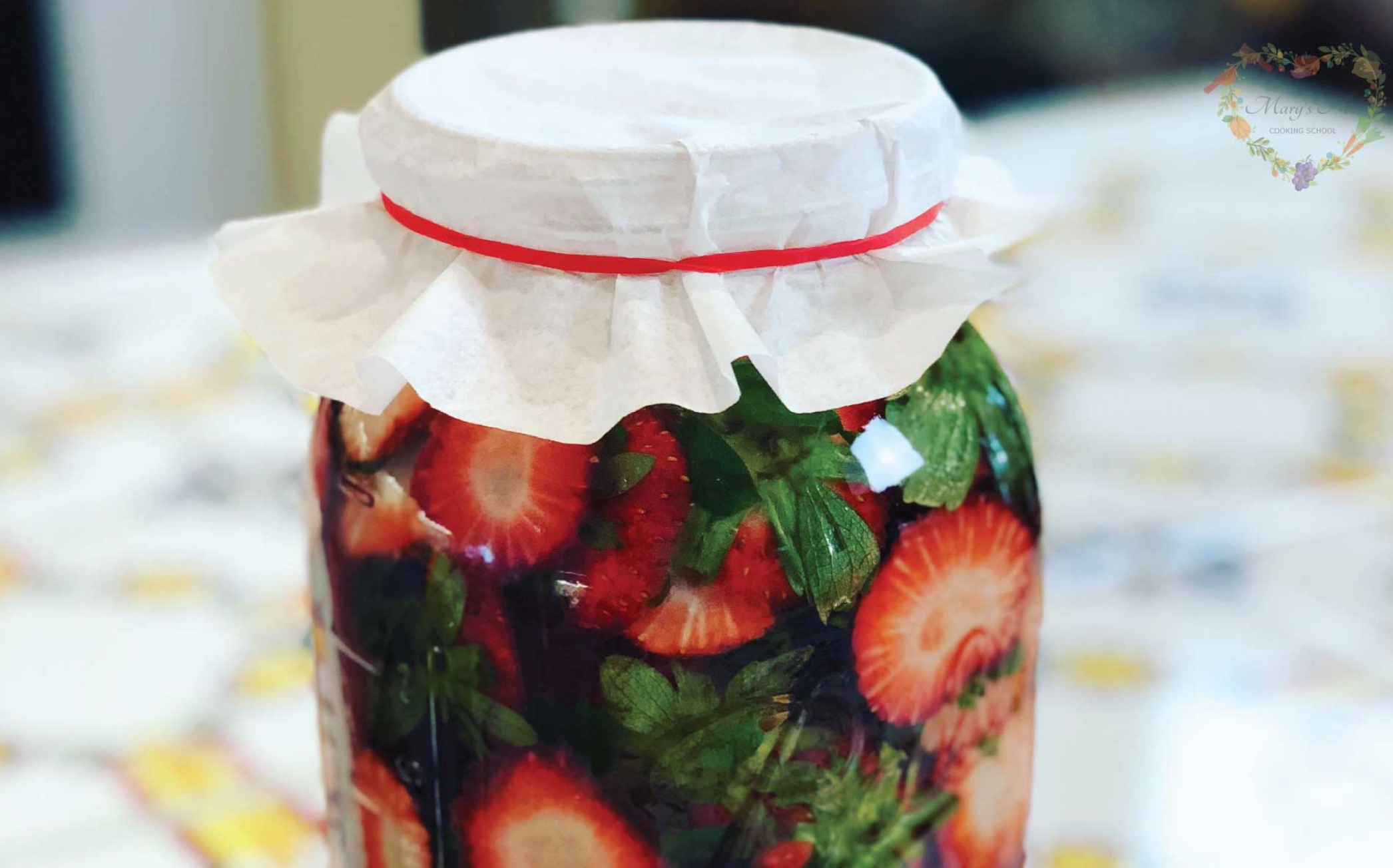 jar full of strawberry tops soaking in vinegar