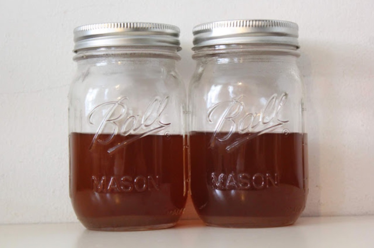 two mason jars half full of vegetable stock