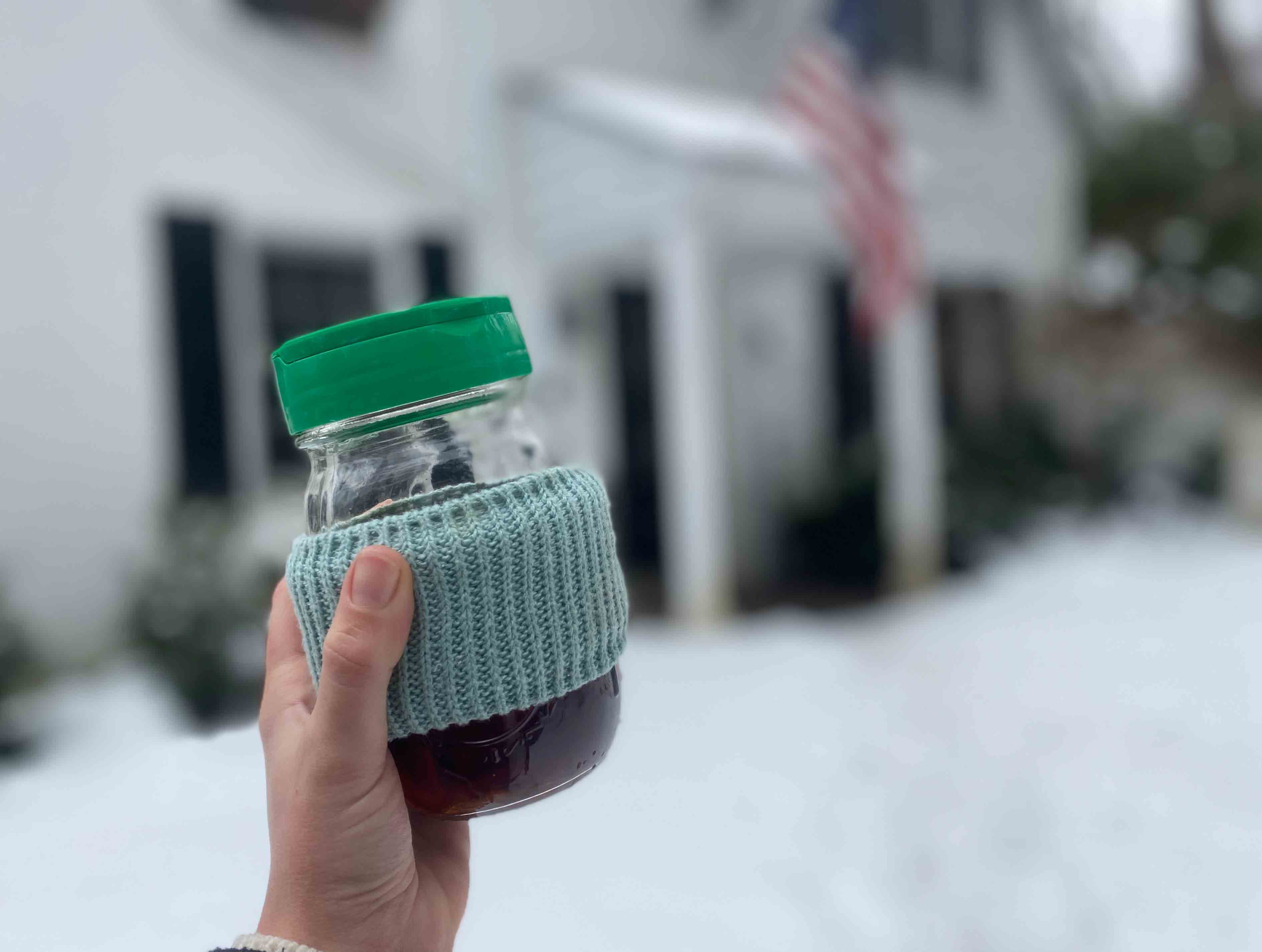 travel mug made from mason jar, parmesan cheese lid and sock